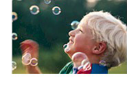 boy blowing bubbles